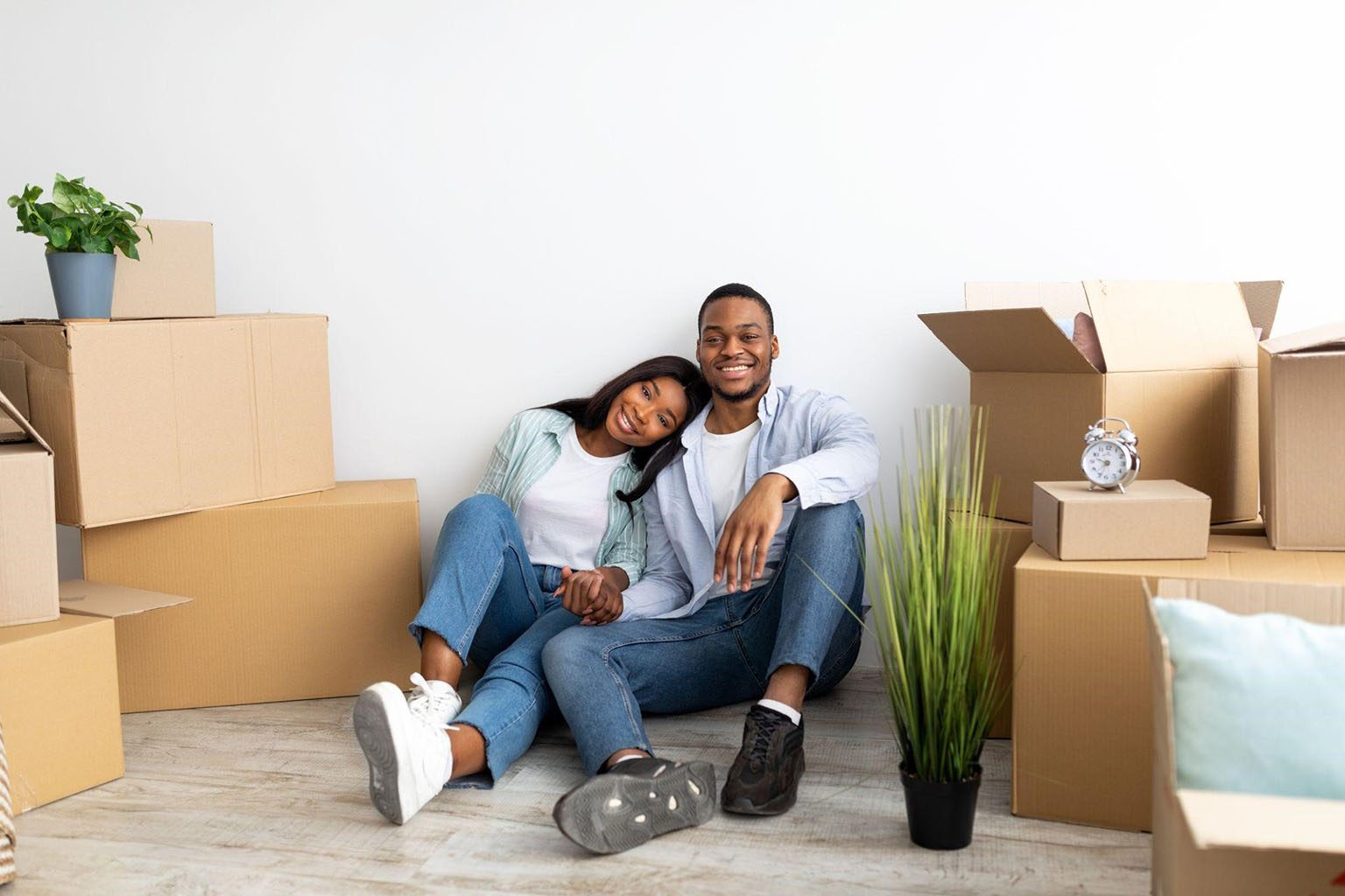 A couple in their new home surrounded by moving boxes