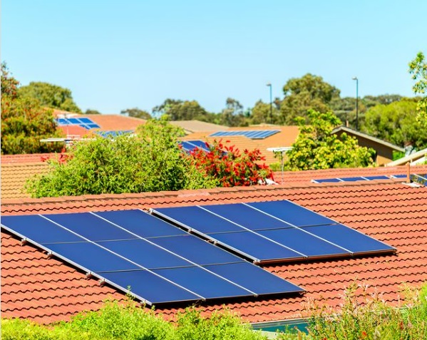 Rows of roofs in a housing community with solar panels installed