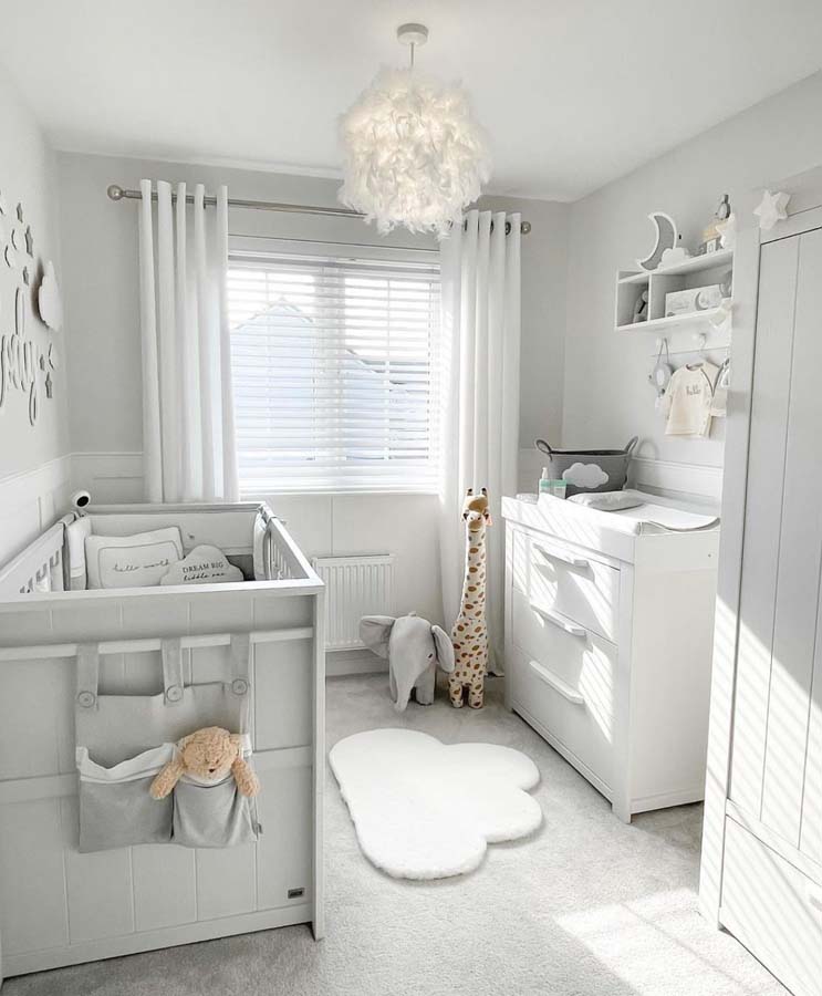Gender-neutral baby room with decorations and storage.