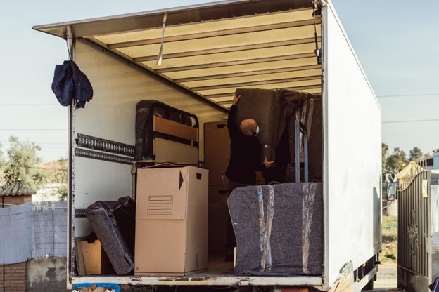 Man loading furniture into a moving truck