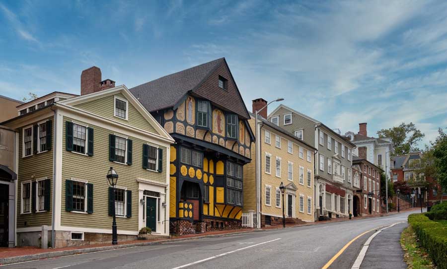 Street view of a row of Rhode Island homes, showcasing the local architecture