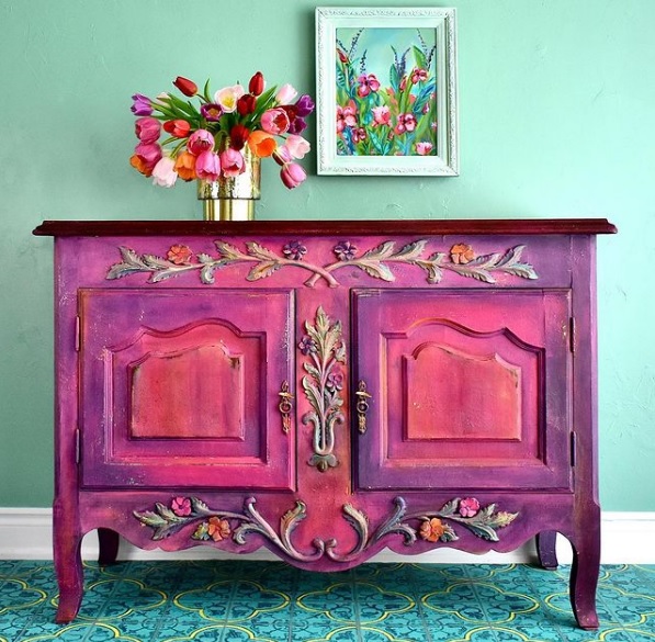 A brightly painted upcycled buffet table