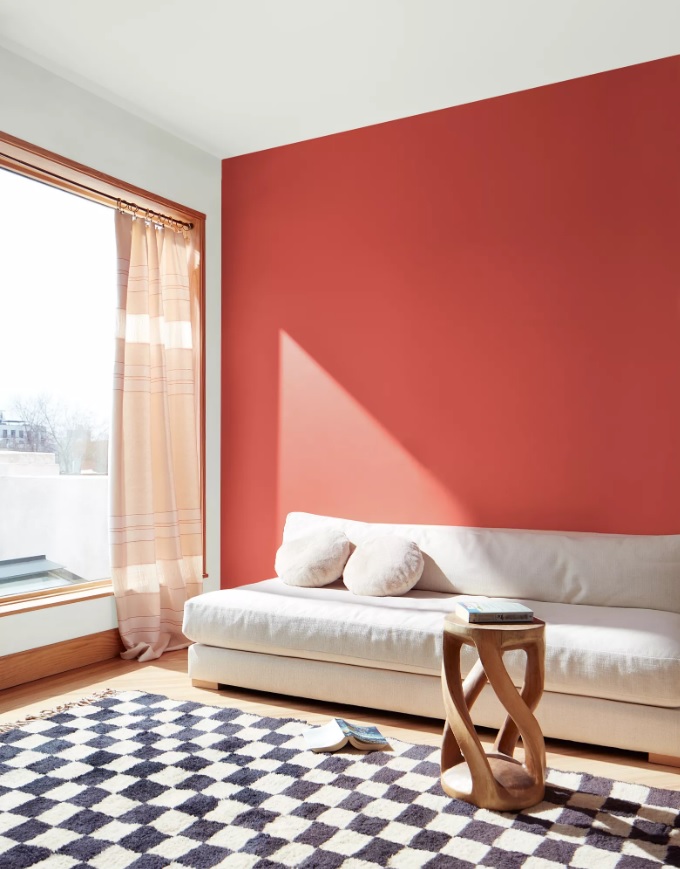 A living room wall painted in the Benjamin Moore 2023 color of the year, Raspberry Blush