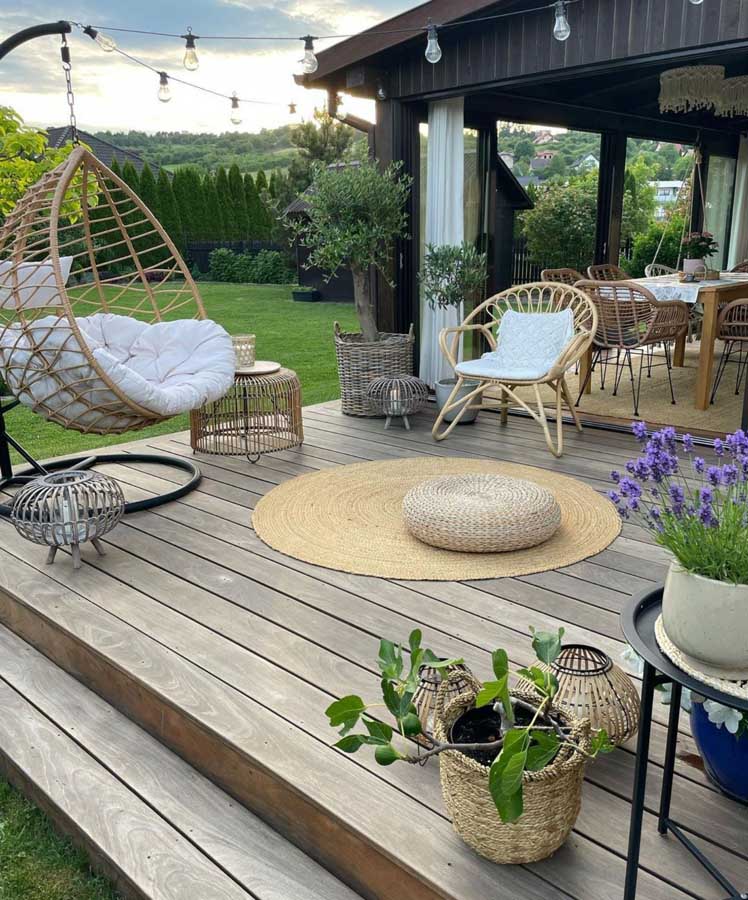 Nature-focused patio with furniture, seated swing, and plants