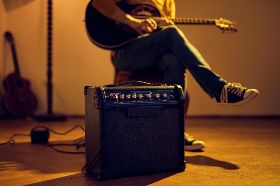 A guitar amp in front of a guitar player