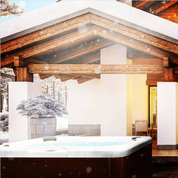 An open hot tub steaming in front of a covered patio as it snows
