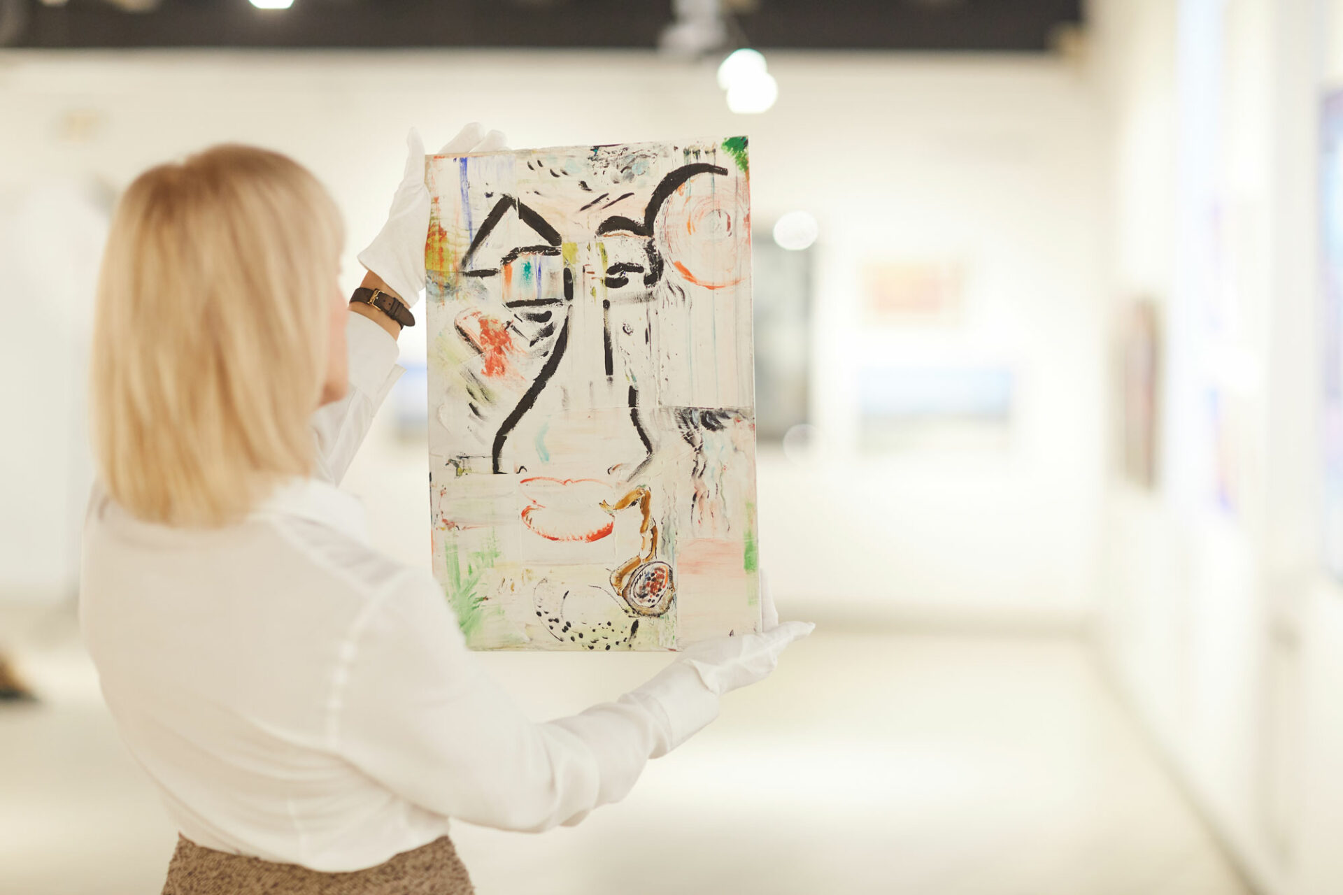 Woman Holding Abstract Painting in Art Gallery