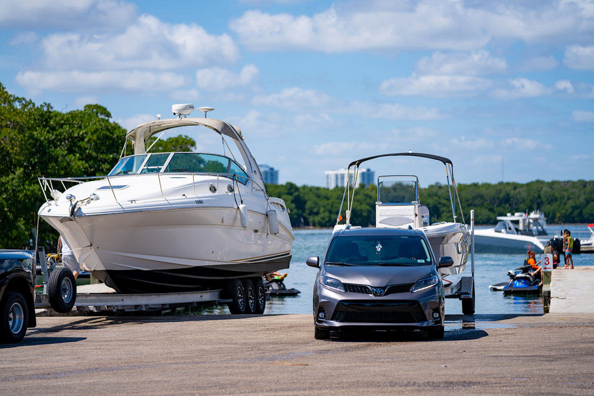 Boat and car paked next to lake