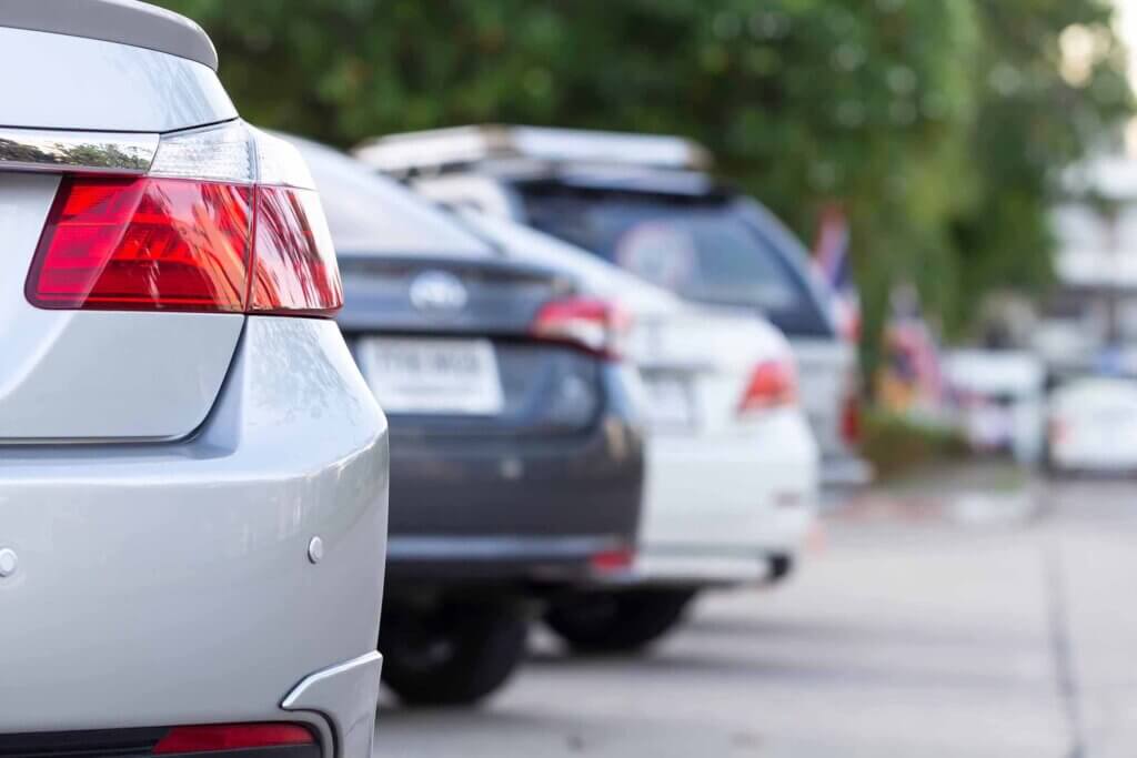 Several cars parked next to each other in staggered spaces